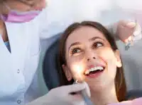 Woman smiling during Invisalign consultation in Forest Hills NY