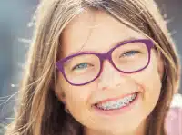 Patient smiling with braces during orthodontic treatment